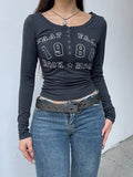 dark blue long sleeve top with letter